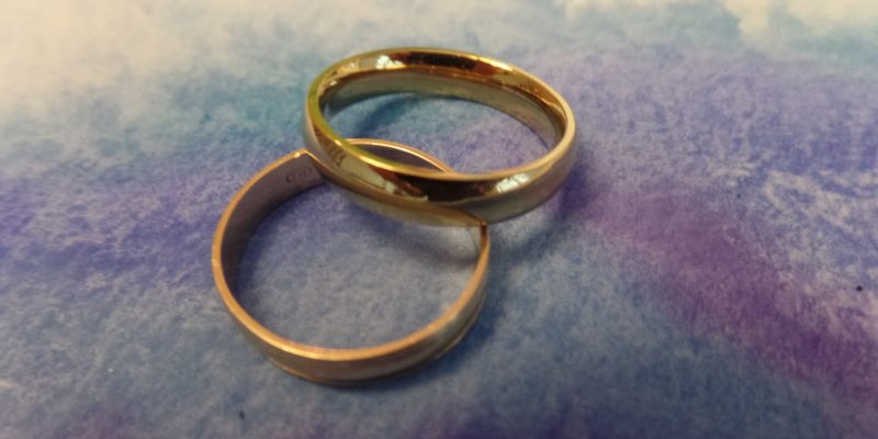 two gold wedding bands resting on each other